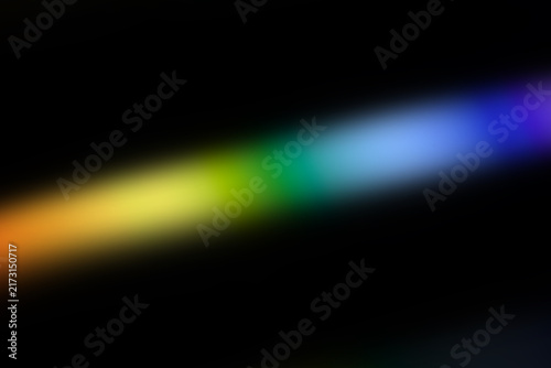 Soft Diagonal Rainbow Light Streak Overlay with Blurred Prismatic Spectrum Glow, Colorful Motion Trail and Copy Space on Black Background