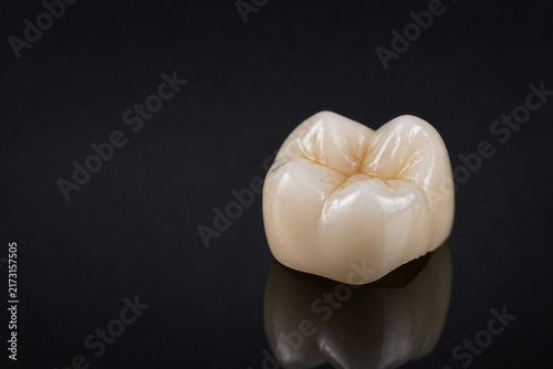 Ceramic dental crown in dramatic studio macro