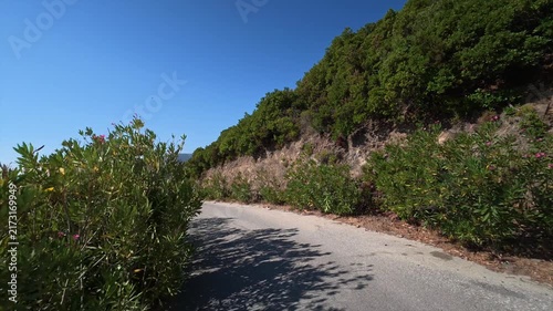 A car drives slowly along a dangerous winding mountain road on the island of Crete, Greece.