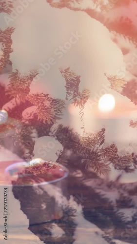 Animation of candles over winter coniferous trees with snow