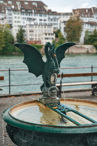 Quadro su tela Traditional Basilisk Fountain with Coat of Arms on the Rhine River Waterfront Pr