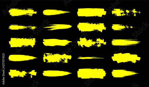 Yellow painted brush strokes collection isolated on black for various graphic design projects