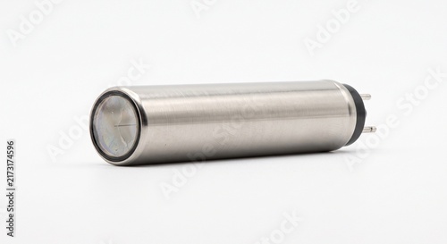 Macro photograph of a bare Geiger-Muller counter tube. Metallic gas cylinder with mica window for ionizing radiation detection. Scientific hardware isolated on white background.