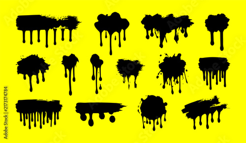 Black paint drip splash grunge ink brush strokes on yellow background