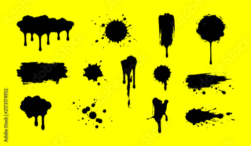 Black paint splatters and drips on yellow background for grunge design elements
