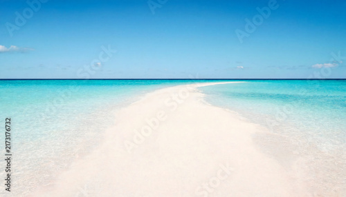 Pristine white sandbar surrounded by crystal clear turquoise ocean water under bright blue sky