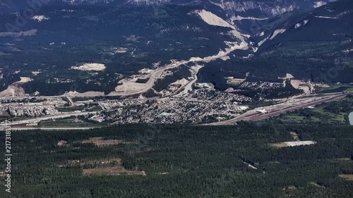 panning left across Golden, a town in southeastern British Columbia, Canada, nestled in the Rocky Mountain Trench 4k aerial video footage 