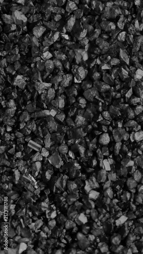 Coal Pieces Shaking. Macro view of black coal fragments trembling and jumping randomly under continuous vibration.