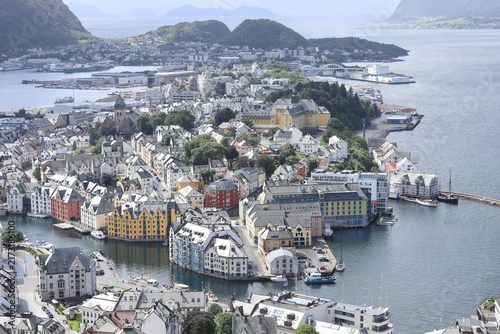 Aerial panoramic view of Alesund town from Aksla hill in Norway. Spectacular landscape of a Norwegian coastal city under dramatic cloudy sky.