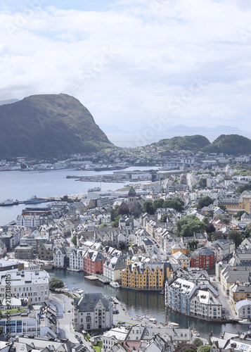 Aerial panoramic view of Alesund town from Aksla hill in Norway. Spectacular landscape of a Norwegian coastal city under dramatic cloudy sky.