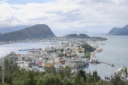 Aerial panoramic view of Alesund town from Aksla hill in Norway. Spectacular landscape of a Norwegian coastal city under dramatic cloudy sky.