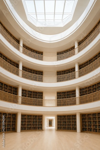 Tiered balconies rising around a bright library atrium