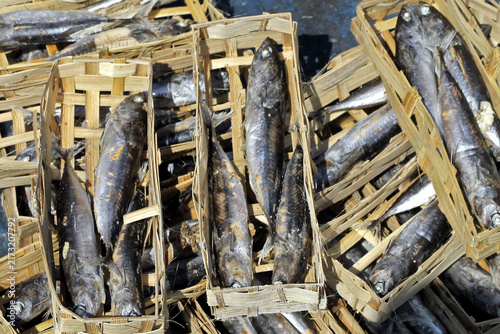 Dried Fish in Woven Baskets at Traditional Seafood Market Packed Salted Fish For Sale