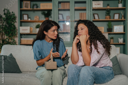 Photography Mother having serious conversation with sulking teenage daughter