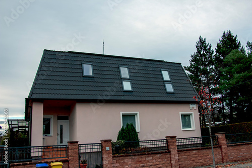 Nitra, Slovakia - November 20, 2024: Detached House with Dark Tiled Roof and Skylights