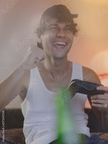 Принти на полотні Young man engrossed in playing video games.