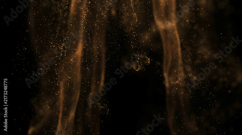 Abstract golden dust particles and glowing smoke flowing on dark background