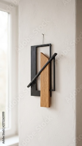 Minimalist Geometric Wall Art Featuring Abstract Metal Frame and Natural Wood Accent Hanging on White Wall