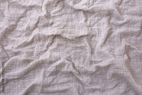Beige wrinkled linen fabric texture close up