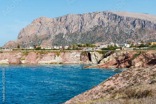 Scenic view of the Terrasini coast, a seaside town in the province of Palermo, Sicily, Italy, characterized by rugged rocky cliffs and crystal-clear waters of the Mediterranean Sea.