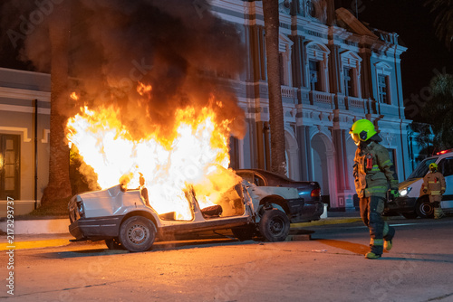 фотографія Firefighters responding to a burning car in front of a historic railway station