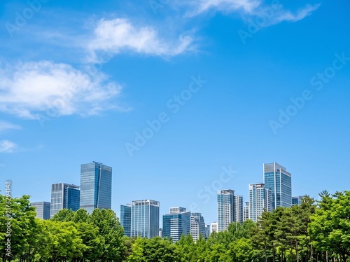 Modern City Skyline Above Green Park With Blue Sky Copy space