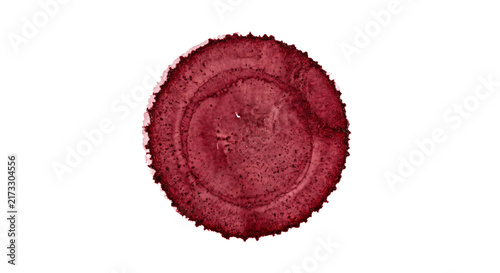 Foto Deep red circular stain with textured rings and irregular edges on white