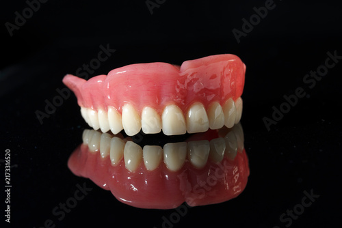 Fotografie Dentistry tools and models on a black background.