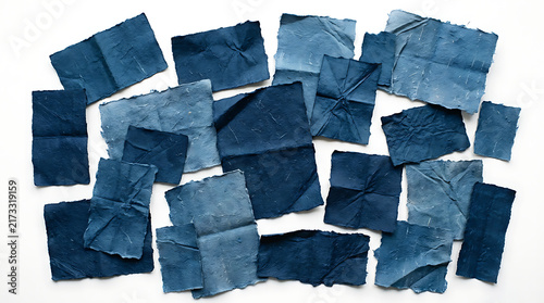Blue denim fabric patches arranged in a messy pile