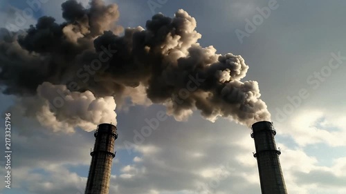 Dramatic smoke plumes billow across the sky, suggesting industry or natural event; the diffused light creates a somber, powerful mood; perfect for environmental or disaster reporting