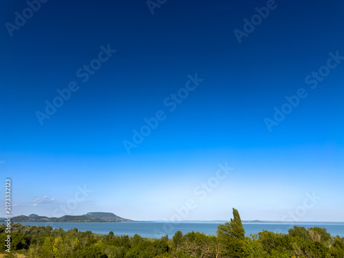 Canvas Print Panoramic lake landscape with distant volcanic hills in Hungary