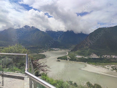 Konstfotografi The Yarlung Tsangpo river and the mountain village of Pai Town seen from a metal