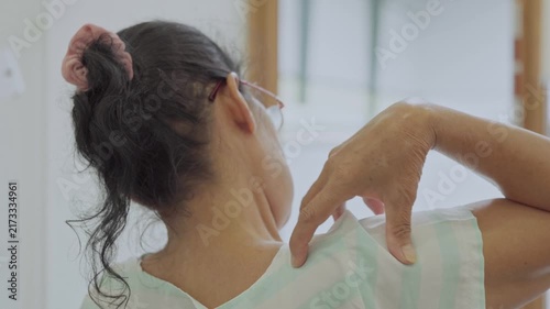 Asian senior woman use hand squeeze nape to relieves symptoms cramps, pain muscle, osteoporosis. Elderly female patient massages shoulder, arm for lifestyle healthcare, arthritis aches. Wellness 