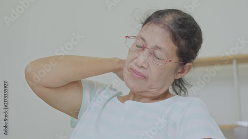 Asian senior woman use hand squeeze nape to relieves symptoms cramps, pain muscle, osteoporosis. Elderly female patient massages shoulder, arm for lifestyle healthcare, arthritis aches. Wellness 