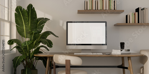 Принти на полотні Minimalist home office workspace mockup with blank screen computer monitor on wooden table, bookshelf, and houseplant
