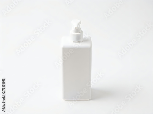 White plastic bottle with a pump dispenser for liquid soap isolated on white background
