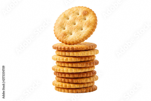 Foto Tall stack of golden salty crackers with one balanced on top