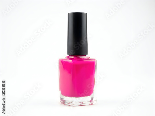 Bright pink nail polish bottle with black cap isolated on white background