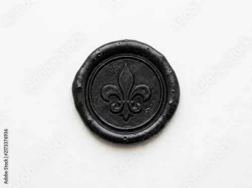 Fototapeta na wymiar Black wax seal with fleur de lis emblem on white background.