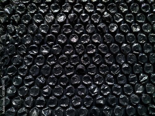 Black plastic bubble wrap packaging texture background.