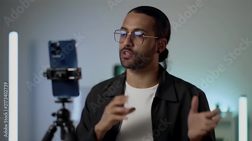 Young man recording video content on smartphone for social media and digital marketing