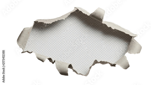 A hole torn in a piece of rough textured paper