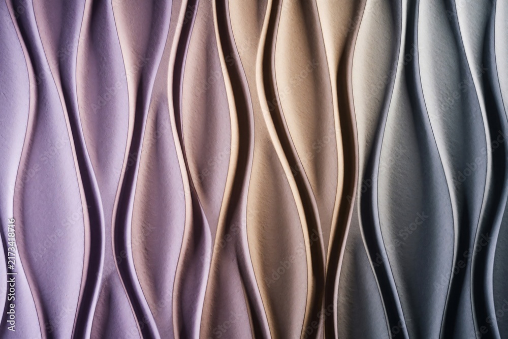 Obraz premium Textured panel features vertical wavy patterns in purple beige and grey tones. Smooth surface creates shadow and light play, offering modern abstract decor. This design adds depth.