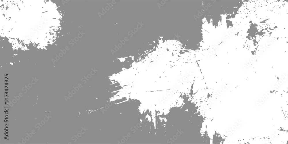 Fototapeta premium Abstract textured white paint splatters on a muted grey background create a dynamic and artistic composition.