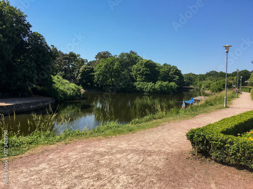 Peaceful park landscape with pond and pathway