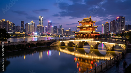 Traditional Chinese pavilion on a stone bridge at night with modern city skyline view