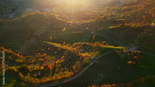 Flying Above Scenic Autumn Mountain Valley Illuminated by Warm Sunlight