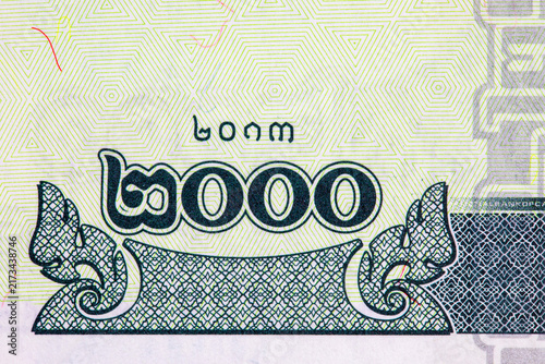 Macro detail of a 2000 Cambodian Riel banknote showing Khmer script, denomination numerals, intricate geometric security patterns, and fine guilloche engraving.