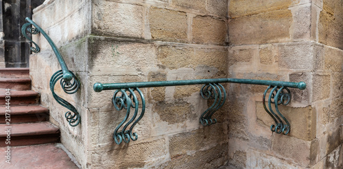 Quadro su tela Old inclined and angled metal handrails on wall historical building