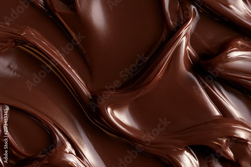 Rich chocolate spread on a surface with smooth and glossy texture